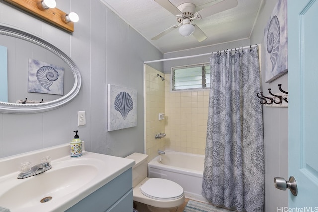 full bathroom with a textured ceiling, toilet, ceiling fan, vanity, and shower / tub combo with curtain