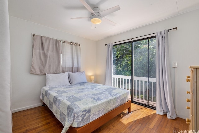 bedroom featuring access to outside, hardwood / wood-style flooring, and ceiling fan