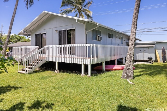 back of house featuring a wooden deck, cooling unit, and a lawn