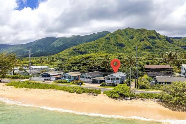 birds eye view of property featuring a water and mountain view