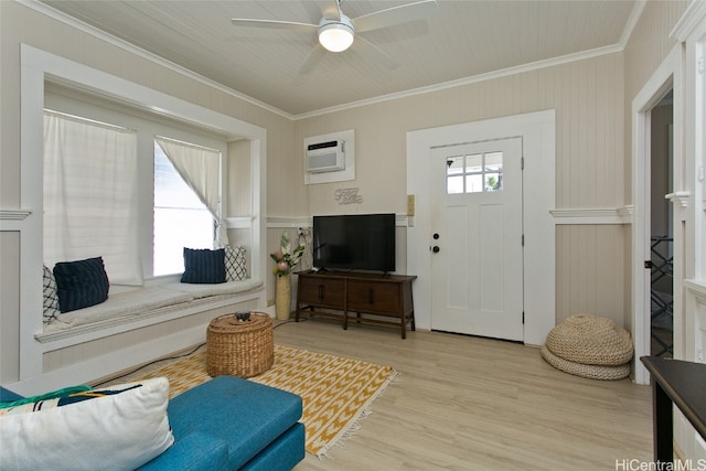 living room featuring crown molding, a wall mounted AC, light wood-type flooring, and ceiling fan