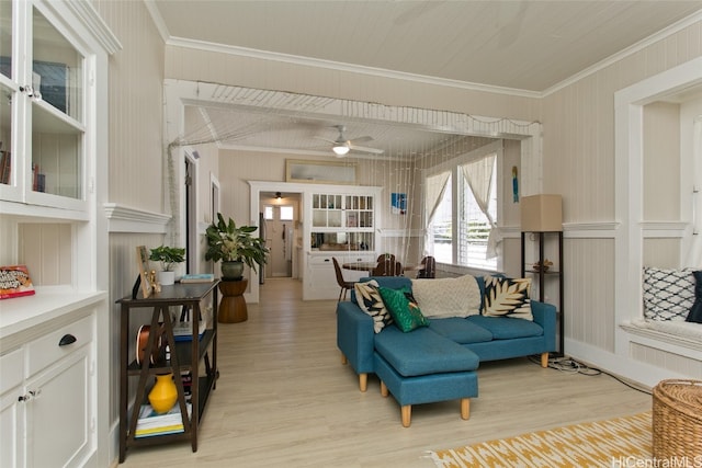 living room with crown molding, light wood-type flooring, and ceiling fan