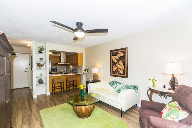 living room with dark hardwood / wood-style floors and ceiling fan