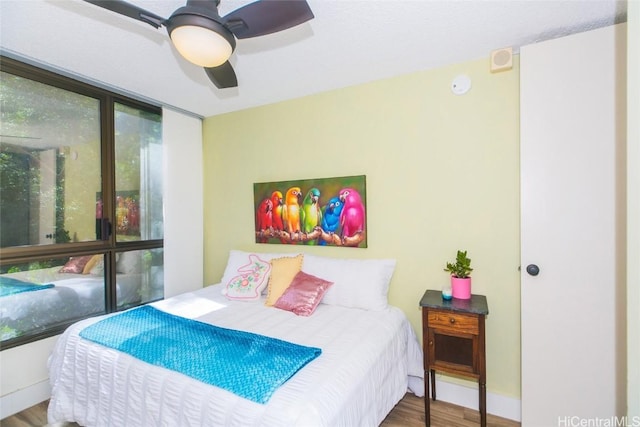 bedroom with hardwood / wood-style floors and ceiling fan