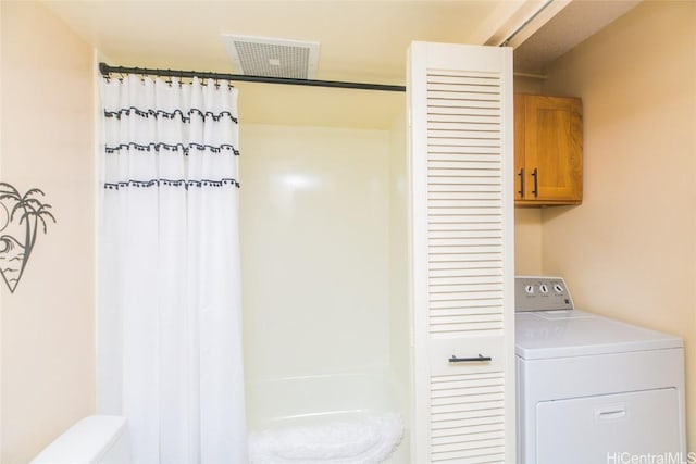 laundry room featuring washer / clothes dryer and cabinets