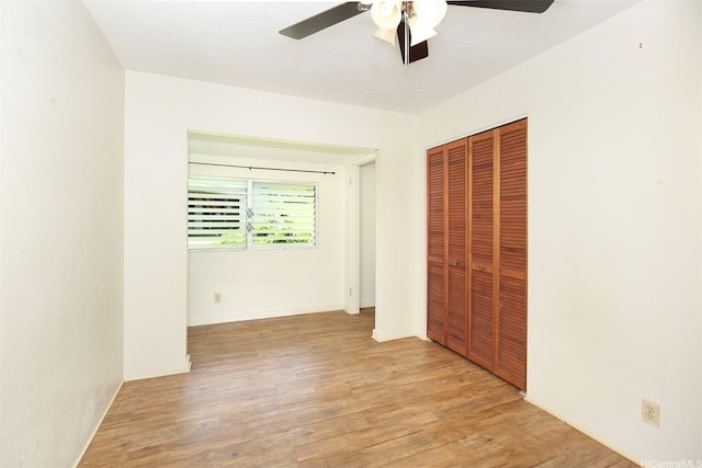 3360 E Manoa Rd Unit C, Honolulu, HI 96822 - unfurnished bedroom featuring a closet, light wood-style floors, and a ceiling fan