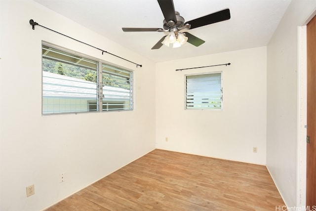 empty room with light hardwood / wood-style flooring and ceiling fan