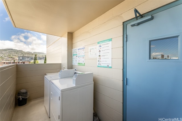 washroom with washer and clothes dryer and a mountain view