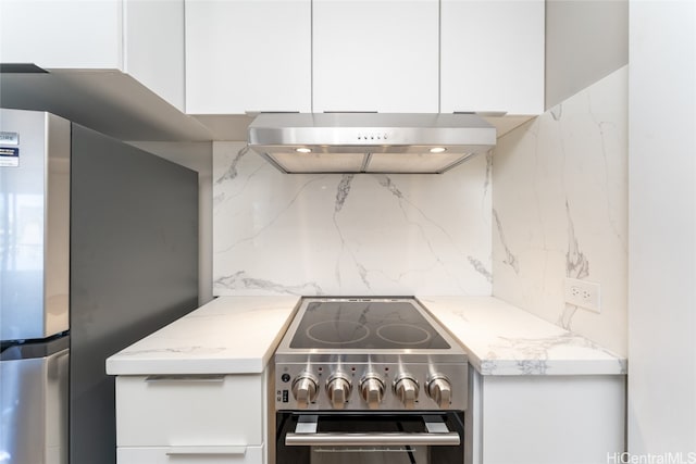 kitchen with extractor fan, white cabinetry, tasteful backsplash, and stainless steel appliances