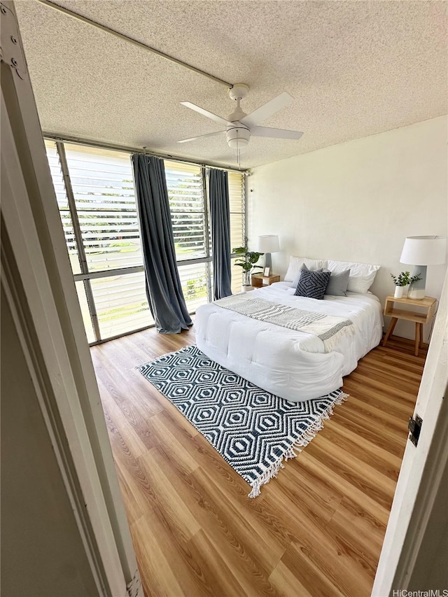 95-2047 Waikalani Pl Unit D305, Mililani, HI 96789 - bedroom featuring a textured ceiling, wood finished floors, and ceiling fan