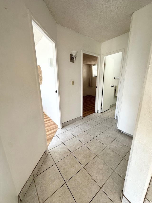 95-2047 Waikalani Pl Unit D305, Mililani, HI 96789 - corridor featuring light tile patterned floors and a textured ceiling