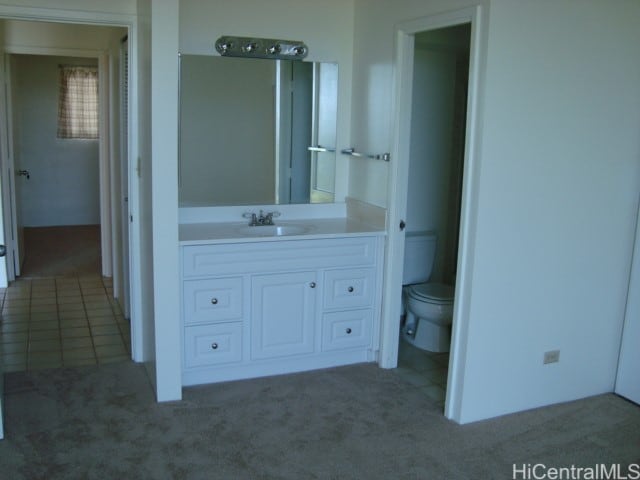 bathroom with vanity, toilet, and tile patterned flooring