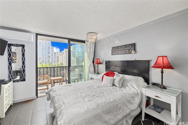 bedroom with a textured ceiling, a wall of windows, and a wall unit AC