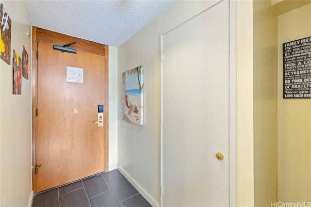 corridor featuring a textured ceiling