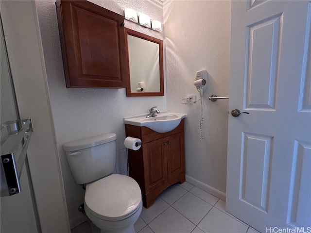 bathroom with vanity, toilet, and tile patterned floors