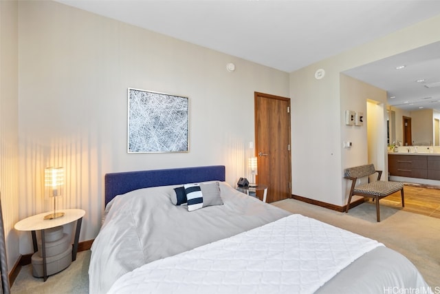 carpeted bedroom featuring ensuite bathroom