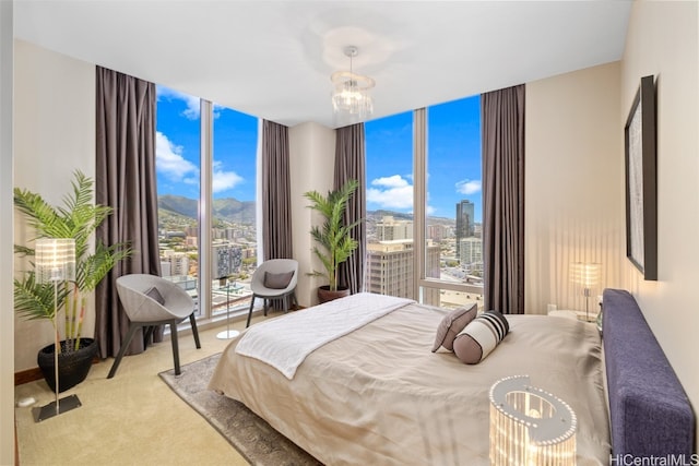 carpeted bedroom featuring expansive windows and multiple windows