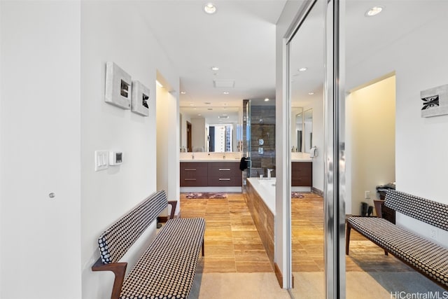 bathroom with vanity, hardwood / wood-style floors, and independent shower and bath