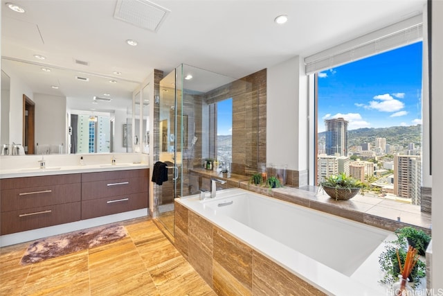 bathroom featuring vanity and separate shower and tub