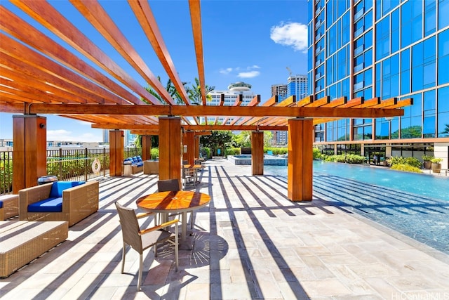 view of community with a pergola, a patio area, and an outdoor living space