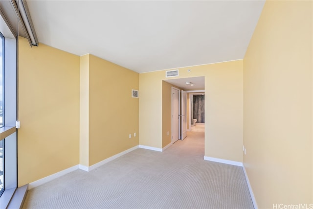 empty room featuring light carpet