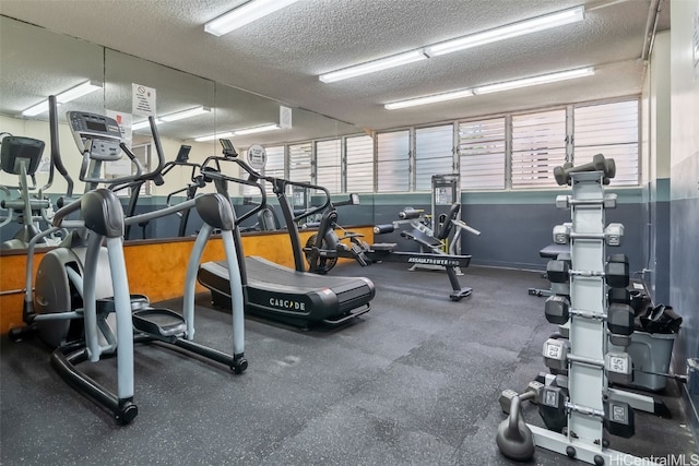 exercise room with a textured ceiling