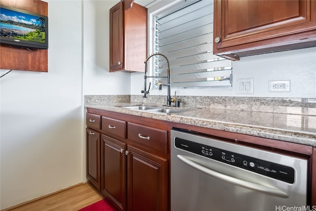 kitchen featuring sink, dishwasher, and light hardwood / wood-style flooring