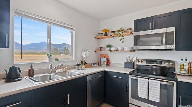 87-1950 Pakeke St Unit F, Waianae, HI 96792 - kitchen with appliances with stainless steel finishes, light countertops, a mountain view, and open shelves