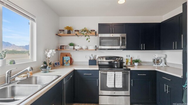 87-1950 Pakeke St Unit F, Waianae, HI 96792 - kitchen with stainless steel appliances, open shelves, light countertops, and a mountain view