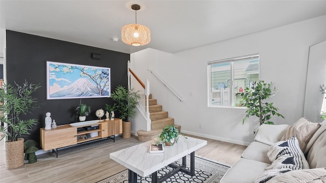 87-1950 Pakeke St Unit F, Waianae, HI 96792 - living room featuring light wood-type flooring, stairs, and an accent wall