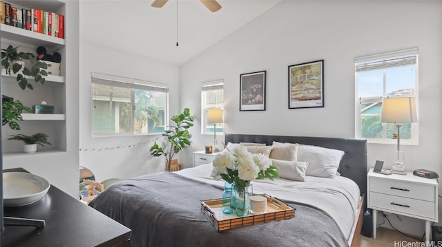 bedroom featuring multiple windows, vaulted ceiling, and ceiling fan