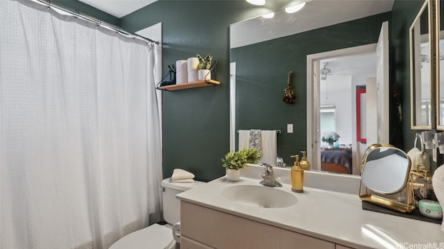 bathroom featuring walk in shower, ceiling fan, vanity, and toilet