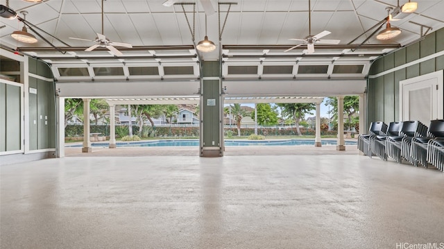 interior space featuring ceiling fan and a community pool