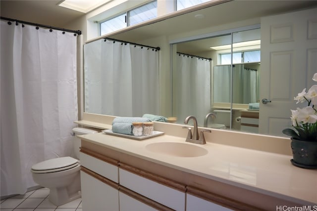 bathroom featuring tile patterned flooring, vanity, and toilet