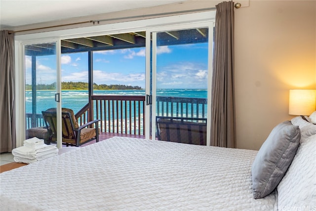 bedroom with access to exterior and a water view