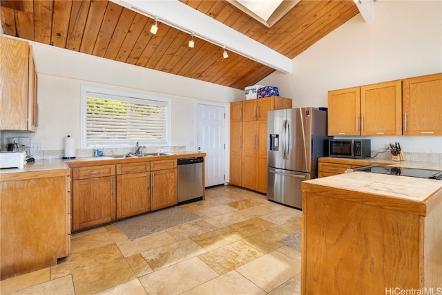 kitchen with appliances with stainless steel finishes, sink, wood ceiling, beamed ceiling, and high vaulted ceiling