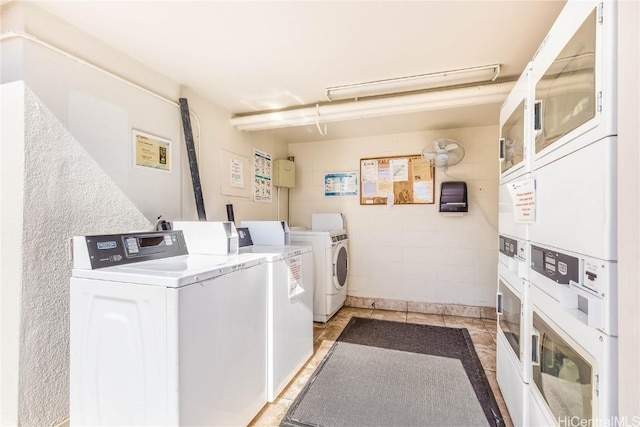 washroom with washer and dryer and stacked washer and dryer