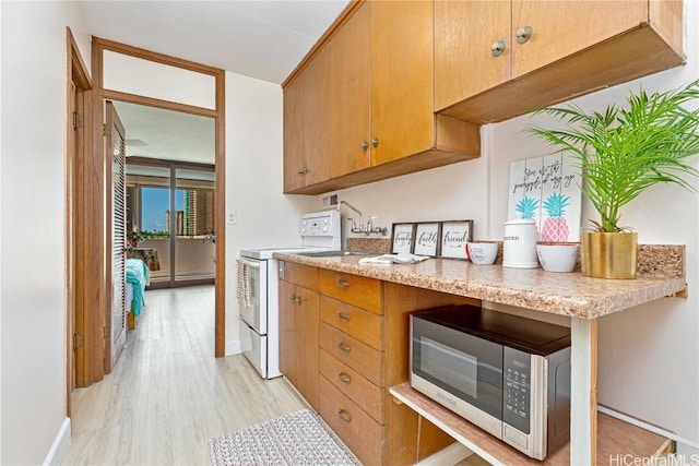 kitchen featuring light hardwood / wood-style floors and white stove