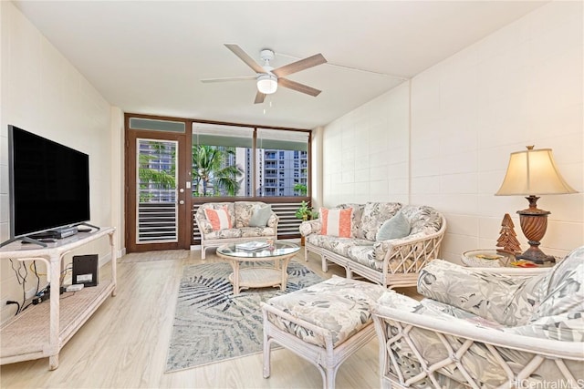 living room with ceiling fan and light hardwood / wood-style floors