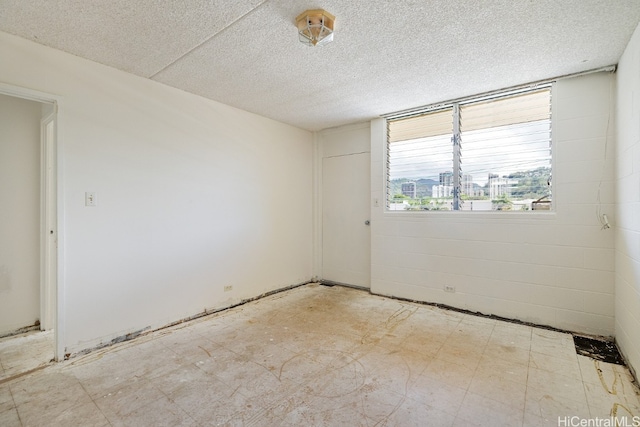 empty room with a textured ceiling