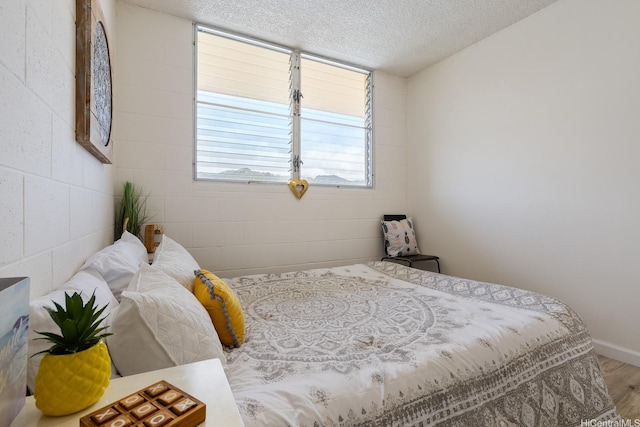 24 Hialoa St Unit 41, Honolulu, HI 96817 - bedroom featuring a textured ceiling, baseboards, and wood finished floors