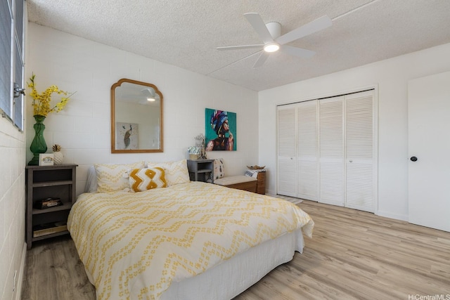 24 Hialoa St Unit 41, Honolulu, HI 96817 - bedroom with a ceiling fan, a textured ceiling, wood finished floors, concrete block wall, and a closet