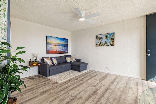 24 Hialoa St Unit 41, Honolulu, HI 96817 - living room with concrete block wall, a textured ceiling, a ceiling fan, and wood finished floors