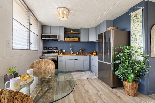 24 Hialoa St Unit 41, Honolulu, HI 96817 - kitchen with a sink, gray cabinets, stainless steel appliances, and light wood-type flooring