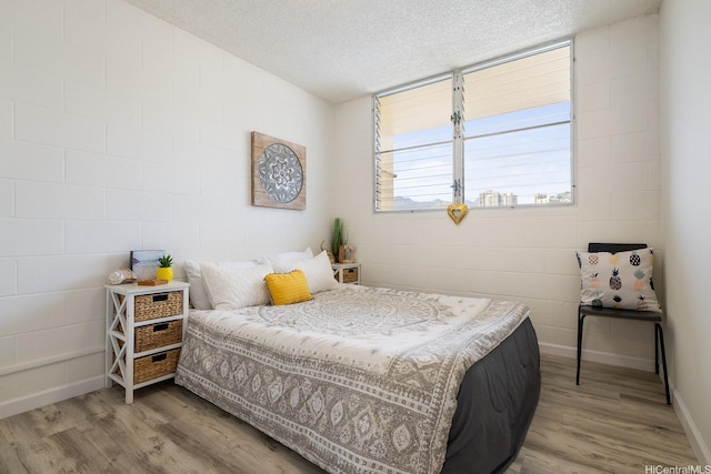 24 Hialoa St Unit 41, Honolulu, HI 96817 - bedroom with a textured ceiling, baseboards, and wood finished floors