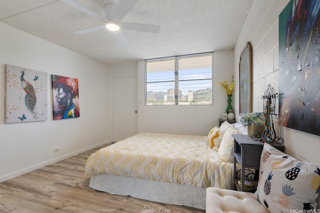 24 Hialoa St Unit 41, Honolulu, HI 96817 - bedroom with a ceiling fan, a textured ceiling, and wood finished floors