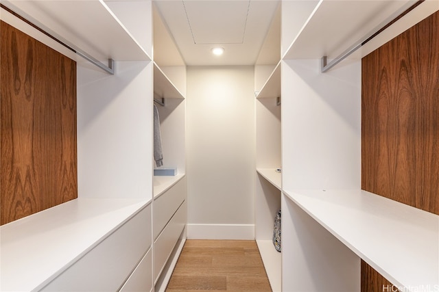 spacious closet with light hardwood / wood-style flooring