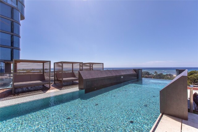 view of pool with a water view