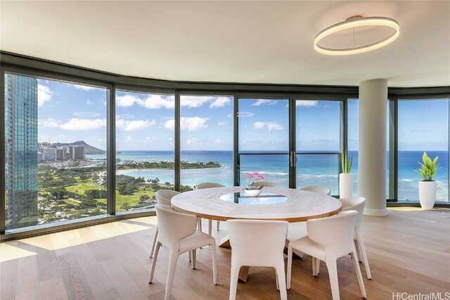 sunroom featuring a water view and a wealth of natural light