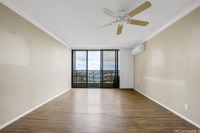 empty room with a wall unit AC, ceiling fan, hardwood / wood-style flooring, floor to ceiling windows, and crown molding